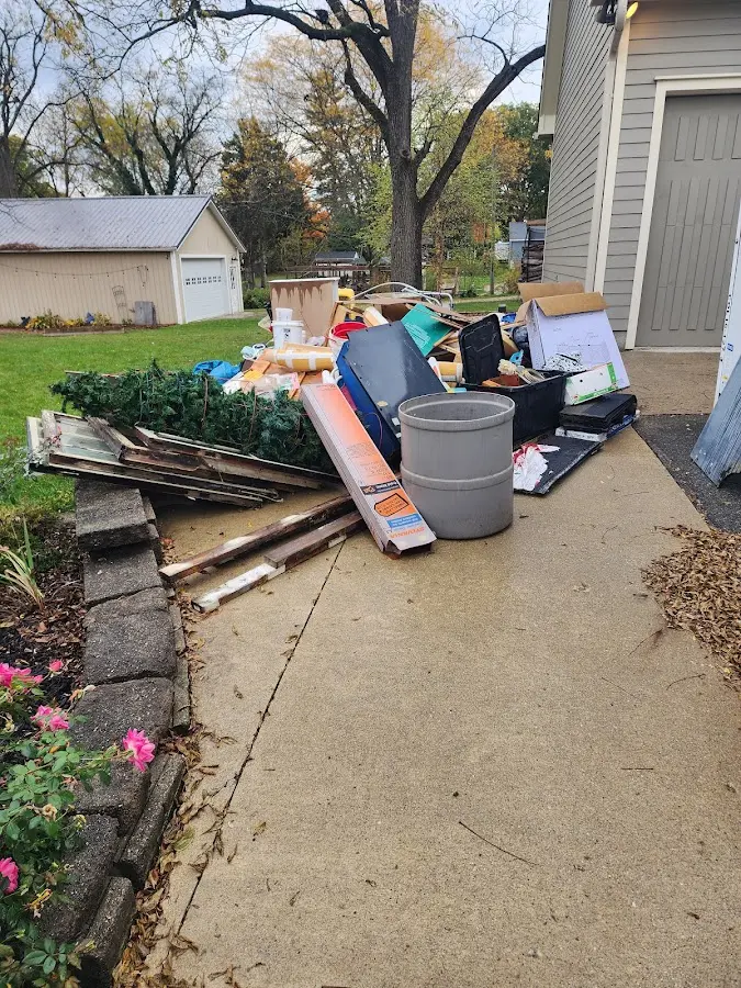 Dumpster being loaded with debris for 10 Yard Dumpster Rental in Clinton